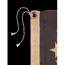 13 STARS ON A DUSTY BLUE CANTON, IN AN OVAL VERSION OF WHAT IS KNOWN AS THE 3RD MARYLAND PATTERN, MADE DURING THE LAST DECADE OF THE 19TH CENTURY, MARKED WITH THE SURNAME “NYE”
