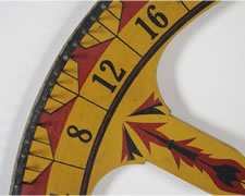 GAME WHEEL IN CHROME YELLOW PAINT WITH DECORATION REMINISCENT OF AMERICAN INDIAN ART, CHICAGO, 1910-20