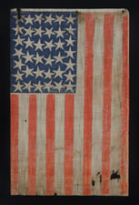 38 STAR FLAG WITH ESPECIALLY LARGE STARS AND INTERTWINED ARMS, AN ANTIQUE EXAMPLE REFLECTING COLORADO STATEHOOD, 1876-1889