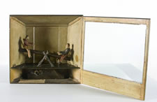 CLOCKWORK ACTION TOY, BOYS ON A SEESAW, WITH A PERIOD, HANDWRITTEN NOTE, ca 1870-80