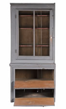 NARROW, MAKE-DO PENNSYLVANIA CUPBOARD IN OLD GREY PAINT OVER AN EARLIER RED, WITH A GLAZED DOOR AND TWO UNUSUAL DROP-DOWN DOORS, CA 1890