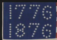 ANTIQUE AMERICAN FLAG WITH 10-POINTED STARS ARRANGED TO SPELL "1776 - 1876", ONE OF THE MOST GRAPHIC OF ALL EARLY EXAMPLES