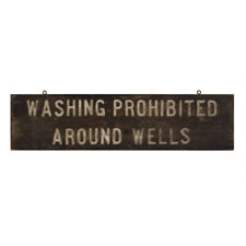 "WASHING PROHIBITED AROUND WELLS", AN EARLY-MID 20TH CENTURY SIGN
