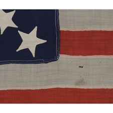 37 STARS IN A MEDALLION CONFIGURATION ON AN ANTIQUE AMERICAN FLAG OF THE 1867-1876 PERIOD, IN A RARE AND DESIRABLE SMALL SIZE, NEBRASKA STATEHOOD