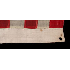 18 STAR ANTIQUE AMERICAN FLAG WITH 13 STRIPES, A “DISUNION” FLAG, MADE WITH AN ABOLITIONIST MESSAGE, circa 1859-1861, EXCLUDING THE SLAVE STATES; WITH A 19th STAR ADDED ON THE OBVERSE; OWNED BY HARVARD-TRAINED, MASSACHUSETTS PHYSICIAN BENJAMIN CUSHING, WHO VOLUNTEERED AS A U.S. ARMY SURGEON, DEVOID OF RANK OR PAY, STATIONED AT FORT MONROE, VIRGINIA, ‘CONTRABAND CAMP’ FOR ESCAPING SLAVES AND THE ONLY UNION-CONTROLLED, FORTIFIED BASE IN THE UPPER SOUTH