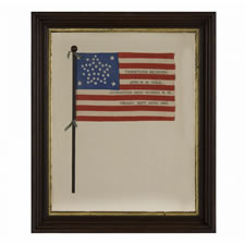 38 STAR ANTIQUE AMERICAN FLAG WITH A RARE AND BEAUTIFUL VARIATION OF THE "GREAT STAR" OR "GREAT LUMINARY" PATTERN, AN EXAMPLE OF EXTRAORDINARY QUALITY, MADE BY R.W. MUSGROVE IN BRISTOL, NEW HAMPSHIRE FOR AN 1885 REUNION OF THE 12th NH VOLUNTEERS