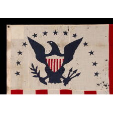 LATE 19th CENTURY FLAG OF THE REVENUE MARINE (a.k.a., REVENUE CUTTER SERVICE), WITH A BLUE EAGLE AMID AN ARCH OF 13 BLUE STARS, ON A WHITE CANTON, AND 16 RED & WHITE, VERTICAL STRIPES, MADE circa 1885-1895