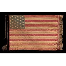27 STARS AND 15 STRIPES ON A HOMEMADE FLAG WITH ITS CANTON RESTING ON THE WAR STRIPE AND WITH A HIGHLY UNUSUAL FRINGE AND TASSEL; AN EXTREMELY RARE STAR COUNT, MADE DURING THE CIVIL WAR, BOTH TO COMMEMORATE FLORIDA AS THE 27TH STATE AND ILLUSTRATE ITS UNITY WITH THE SOUTH