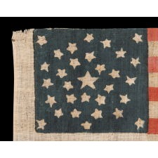 31 STAR ANTIQUE AMERICAN FLAG WITH A RARE AND BEAUTIFUL PENTAGON MEDALLION CONFIGURATION OF STARS; REFLECTS THE PERIOD WHEN CALIFORNIA WAS THE MOST RECENT STATE TO JOIN THE UNION, 1850-1858; THE ONLY EXAMPLE IN THIS EXACT FORM THAT I HAVE ENCOUNTERED