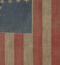 31 STARS AND 17 STRIPES, THE ONLY KNOWN EXAMPLE IN THIS STYLE WITH A "GREAT STAR" PATTERN THAT CONTAINS A GIGANTIC CENTER STAR AND 17 STRIPES, PROBABLY MADE WITH SOUTHERN SYMPATHIES, CANTON RESTING ON THE "BLOOD STRIPE", PRE-CIVIL WAR, CALIFORNIA STATEHOO