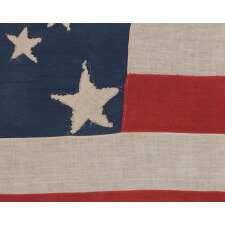 31 STARS IN A MEDALLION PATTERN ON AN ELONGATED, HOMEMADE, ANTIQUE AMERICAN FLAG WITH A VERTICALLY-ORIENTED CANTON AND EXCEPTIONAL FOLK QUALITIES, PRE-CIVIL WAR, CALIFORNIA STATEHOOD, 1850-1858