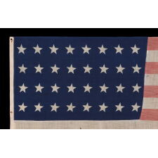 32 STAR ANTIQUE AMERICAN FLAG OF A TYPE KNOWN TO HAVE LIKELY SEEN MILITARY USE, REFLECTS THE ADDITION OF MINNESOTA TO THE UNION IN 1858, AN EXTREMELY RARE FLAG, ACCURATE FOR JUST 9 MONTHS AND OFFICIAL FOR ONLY ONE YEAR