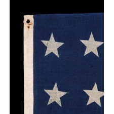 32 STAR ANTIQUE AMERICAN FLAG OF A TYPE KNOWN TO HAVE LIKELY SEEN MILITARY USE, REFLECTS THE ADDITION OF MINNESOTA TO THE UNION IN 1858, AN EXTREMELY RARE FLAG, ACCURATE FOR JUST 9 MONTHS AND OFFICIAL FOR ONLY ONE YEAR