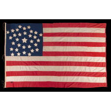 32 STARS IN A VERY UNUSUAL NOTCHED VERSION OF THE “GREAT STAR” PATTERN, WITH TWO STARS ABSENT AT THE EXTREME POINTS OF EACH ARM, MADE IN THE PERIOD WHEN MINNESOTA JOINED THE UNION AS THE 32nd STATE; A VERY RARE STAR COUNT, OFFICIAL FOR JUST ONE YEAR, AND ACCURATE FOR JUST NINE MONTHS, 1858-59