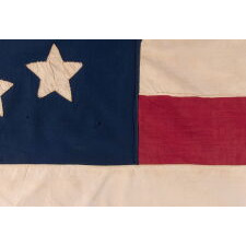 32 STARS IN A VERY UNUSUAL NOTCHED VERSION OF THE “GREAT STAR” PATTERN, WITH TWO STARS ABSENT AT THE EXTREME POINTS OF EACH ARM, MADE IN THE PERIOD WHEN MINNESOTA JOINED THE UNION AS THE 32nd STATE; A VERY RARE STAR COUNT, OFFICIAL FOR JUST ONE YEAR, AND ACCURATE FOR JUST NINE MONTHS, 1858-59