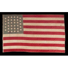 34 HAND-SEWN, UPSIDE-DOWN STARS ON A HOMEMADE, ANTIQUE AMERICAN FLAG WITH A VARIANT OF WHAT I HAVE CLASSIFIED AS A “GLOBAL” PATTERN, ON AN INTERESTING, SEAFOAM BLUE CANTON; REFLECTS KANSAS STATEHOOD, OPENING TWO YEARS OF THE CIVIL WAR, 1861-1863