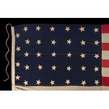 34 STAR ANTIQUE AMERICAN FLAG, ONE OF JUST TWO U.S. NAVY ENSIGNS I HAVE ENCOUNTERED WITH THE BLACK-INKED STENCIL “N.Y. B.” FOR ‘NAVY YARD, BROOKLYN,’ DATED “1859,” TWO YEARS BEFORE KANSAS WAS ADMITTED AS THE 34TH STATE; MARKED WITH THE NAME OF SAMUEL B. CHILDS, A NEW YORK PHYSICIAN WHO CLERKED FOR THE NAVY, AND SON OF A CAREER NAVAL OFFICER, JAMES CHILDS, WHO SERVED FOR 60 YEARS AS A SAILMAKER (1822-1881)