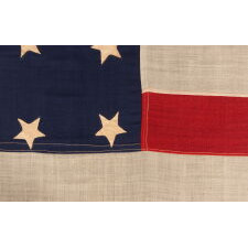 34 STAR ANTIQUE AMERICAN FLAG, ONE OF JUST TWO U.S. NAVY ENSIGNS I HAVE ENCOUNTERED WITH THE BLACK-INKED STENCIL “N.Y. B.” FOR ‘NAVY YARD, BROOKLYN,’ DATED “1859,” TWO YEARS BEFORE KANSAS WAS ADMITTED AS THE 34TH STATE; MARKED WITH THE NAME OF SAMUEL B. CHILDS, A NEW YORK PHYSICIAN WHO CLERKED FOR THE NAVY, AND SON OF A CAREER NAVAL OFFICER, JAMES CHILDS, WHO SERVED FOR 60 YEARS AS A SAILMAKER (1822-1881)