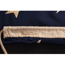 34 STAR ANTIQUE AMERICAN FLAG, ONE OF JUST TWO U.S. NAVY ENSIGNS I HAVE ENCOUNTERED WITH THE BLACK-INKED STENCIL “N.Y. B.” FOR ‘NAVY YARD, BROOKLYN,’ DATED “1859,” TWO YEARS BEFORE KANSAS WAS ADMITTED AS THE 34TH STATE; MARKED WITH THE NAME OF SAMUEL B. CHILDS, A NEW YORK PHYSICIAN WHO CLERKED FOR THE NAVY, AND SON OF A CAREER NAVAL OFFICER, JAMES CHILDS, WHO SERVED FOR 60 YEARS AS A SAILMAKER (1822-1881)