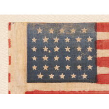 34 STAR ANTIQUE AMERICAN FLAG WITH A LINEAL ARRANGEMENT THAT I HAVE TERMED "GLOBAL ROWS, WITH EXCEPTIONAL COLOR AND CRUDE YET BEAUTIFUL FEATURES, OPENING TWO YEARS OF THE CIVIL WAR, 1861-63, KANSAS STATEHOOD