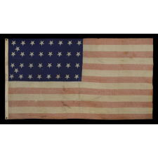 34 STAR ANTIQUE AMERICAN FLAG OF THE CIVIL WAR PERIOD (1861-63), WITH WOVEN STRIPES AND PRESS-DYED OR PRINTED STARS, POSSIBLY MADE IN NEW YORK BY THE ANNIN COMPANY, REFLECTS THE ADDITION OF KANSAS TO THE UNION, 1861-1863