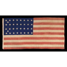 34 STAR ANTIQUE AMERICAN FLAG OF THE CIVIL WAR PERIOD (1861-63), WITH WOVEN STRIPES, PRESS-DYED STARS, AND BEAUTIFUL COLORS, POSSIBLY MADE IN NEW YORK BY THE ANNIN COMPANY, REFLECTS THE ADDITION OF KANSAS TO THE UNION, 1861-1863