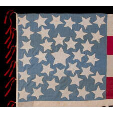 EXCEPTIONAL 34 STAR ANTIQUE AMERICAN CIVIL WAR FLAG WITH A CORNFLOWER BLUE CANTON, HOMEMADE & ENTIRELY HAND-SEWN ca 1861-63, WITH STRIPES THAT BEGIN & END ON WHITE, IN A COUNT OF 9 TO OMIT THE 4 SECEDED STATES FROM AMONG THE ORIGINAL 13 COLONIES, AND WITH APPLIED PANELS THAT READ: “PEACE & LIBERTY”; GIVEN TO DAVIS CAMRON OF “D” Co., 38th OH VOL. BY THE FAMILY OF ORRIN TAYLOR OF “D” & “F” Co.'s, 67th OH INFT'Y, MORTALLY WOUNDED AT APPOMATTOX ON THE VERY DAY OF LEE'S SURRENDER