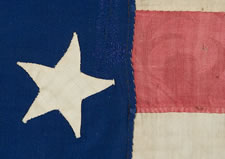 34 STARS, 1861-63, AN EXTRAORDINARY EXAMPLE WITH PATTERNED RED STRIPES, THE ONLY SUCH FLAG KNOWN WITH THIS RARE TRAIT, THOUGHT TO HAVE BEEN MADE BY HANNAH MARIA PERKINS FOR NEW YORK FINANCIAL MAGNATE DANIEL PARISH