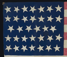 34 STARS, 1861-63, AN EXTRAORDINARY EXAMPLE WITH PATTERNED RED STRIPES, THE ONLY SUCH FLAG KNOWN WITH THIS RARE TRAIT, THOUGHT TO HAVE BEEN MADE BY HANNAH MARIA PERKINS FOR NEW YORK FINANCIAL MAGNATE DANIEL PARISH