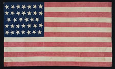 34 STARS, 1861-63, AN EXTRAORDINARY EXAMPLE WITH PATTERNED RED STRIPES, THE ONLY SUCH FLAG KNOWN WITH THIS RARE TRAIT, THOUGHT TO HAVE BEEN MADE BY HANNAH MARIA PERKINS FOR NEW YORK FINANCIAL MAGNATE DANIEL PARISH