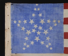 34 STARS IN 4 DIFFERENT SIZES,  ARRANGED IN THE "GREAT STAR" OR "GREAT LUMINARY" PATTERN ON A CORNFLOWER BLUE CANTON, CIVIL WAR PERIOD, 1861-63, KANSAS STATEHOOD