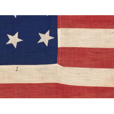 34 STARS IN 4 ROWS WITH 2 STARS OFFSET AT THE HOIST END, ON AN ANTIQUE AMERICAN FLAG LIKELY PRODUCED FOR MILITARY FUNCTION, AS UNION ARMY CAMP COLORS; ONE OF JUST A TINY HANDFUL THAT I HAVE ENCOUNTERED IN THIS EXACT STYLE, REFLECTS KANSAS STATEHOOD, OPENING TWO YEARS OF THE CIVIL WAR, 1861-1863