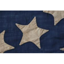 34 STARS ARRANGED IN A BEAUTIFUL RENDITION OF THE MEDALLION CONFIGURATION WITH OFFSET WREATHS AND A LARGE CENTER STAR, MADE DURING THE OPENING YEARS OF THE CIVIL WAR, 1861-1863, AND ENTIRELY HAND-SEWN, REFLECTS KANSAS STATEHOOD
