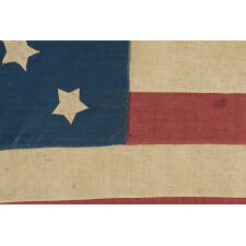 34 STARS ON A HOMEMADE ANTIQUE AMERICAN FLAG OF THE CIVIL WAR ERA, WITH A CORNFLOWER BLUE CANTON AND A VERY INTERESTING CONFIGURATION THAT SUBTLY INCORPORATES THE CROSSES OF ST. ANDREW AND ST. GEORGE, REFLECTS KANSAS STATEHOOD, 1861-63