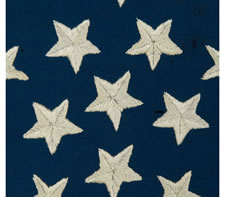 36 HAND-EMBROIDERED STARS IN TWO DIFFERENT SIZES, ARRANGED IN THE FORM OF A WHIMSICAL, INVERTED GREAT STAR PATTERN, AN EXTRAORDINARY HAND-SEWN EXAMPLE IN A RARE, SMALL SIZE, CIVIL WAR PERIOD, NEVADA STATEHOOD, 1864-67