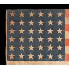 36 STAR ANTIQUE AMERICAN PARADE FLAG OF THE CIVIL WAR ERA, IN AN ESPECIALLY LARGE SCALE, WITH BOLD COLOR, AND ENDEARING WEAR FROM EXTENDED USE, 1864-67, NEVADA STATEHOOD