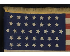 36 STARS IN A VERY ODD LINEAL CONFIGURATION FOR THIS STAR COUNT AND WITH GOLD WOOLEN FRINGE, CIVIL WAR ERA, NEVADA STATEHOOD, 1864-1867, THE ONLY KNOWN EXAMPLE IN THIS STYLE, POSSIBLY A UNION ARMY CAMP MARKER