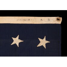 37 STAR ANTIQUE AMERICAN FLAG, ENTIRELY HAND-SEWN THROUGHOUT, WITH JUSTIFIED ROWS OF SINGLE-APPLIQUED STARS, MADE & SIGNED BY THE ANNIN COMPANY IN NEW YORK CITY, WITH SIGNIFICANT WEAR FROM EXTENDED USE; REFLECTS THE ERA WHEN NEBRASKA WAS THE MOST RECENT STATE TO JOIN THE UNION, 1867-1876