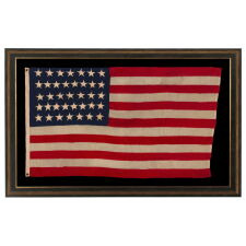 37 STAR ANTIQUE AMERICAN FLAG, MADE & SIGNED BY THE ANNIN COMPANY IN NEW YORK CITY, ENTIRELY HAND-SEWN AND WITH SINGLE-APPLIQUÉD STARS, IN A SMALL AND VERY DESIRABLE SCALE AMONG THOSE WITH PIECED-AND-SEWN CONSTRUCTION; REFLECTS THE ERA WHEN NEBRASKA WAS THE MOST RECENT STATE TO JOIN THE UNION, 1867-1876