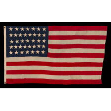 37 STAR ANTIQUE AMERICAN FLAG, MADE & SIGNED BY THE ANNIN COMPANY IN NEW YORK CITY, ENTIRELY HAND-SEWN AND WITH SINGLE-APPLIQUÉD STARS, IN A SMALL AND VERY DESIRABLE SCALE AMONG THOSE WITH PIECED-AND-SEWN CONSTRUCTION; REFLECTS THE ERA WHEN NEBRASKA WAS THE MOST RECENT STATE TO JOIN THE UNION, 1867-1876