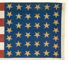 38 STAR ANTIQUE AMERICAN FLAG WITH "1876 CENTENNIAL" ADVERTISING & GOLD STARS, MADE FOR THE CENTENNIAL INTERNATIONAL EXPOSITION IN PHILADELPHIA