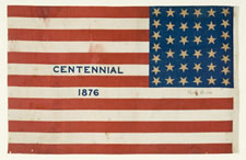 38 STAR ANTIQUE AMERICAN FLAG WITH "1876 CENTENNIAL" ADVERTISING & GOLD STARS, MADE FOR THE CENTENNIAL INTERNATIONAL EXPOSITION IN PHILADELPHIA