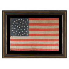 38 STAR ANTIQUE AMERICAN FLAG WITH A TRIPLE-WREATH STYLE MEDALLION CONFIGURATION AND 2 OUTLIERS, ON A LARGE SCALE PARADE FLAG, 1876-1889, COLORADO STATEHOOD