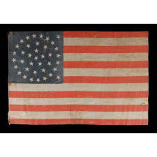 38 STAR ANTIQUE AMERICAN FLAG WITH A TRIPLE-WREATH STYLE MEDALLION CONFIGURATION AND 2 OUTLIERS, ON A LARGE SCALE PARADE FLAG, 1876-1889, COLORADO STATEHOOD