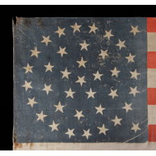 38 STAR ANTIQUE AMERICAN FLAG WITH A TRIPLE-WREATH STYLE MEDALLION CONFIGURATION AND 2 OUTLIERS, ON A LARGE SCALE PARADE FLAG, 1876-1889, COLORADO STATEHOOD