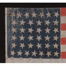 38 STAR ANTIQUE AMERICAN FLAG WITH SCATTERED STAR POSITIONING MADE DURING THE PERIOD WHEN COLORADO WAS THE MOST RECENT STATE ADDED TO THE UNION, 1876-1889