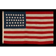 38 STAR ANTIQUE AMERICAN FLAG WITH HAND-SEWN STARS IN AN 8-7-8-7-8 PATTERN OF JUSTIFIED ROWS, MADE IN THE PERIOD WHEN COLORADO WAS THE MOST RECENT STATE TO JOIN THE UNION, 1876-1889