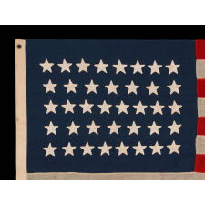 38 STAR ANTIQUE AMERICAN FLAG WITH HAND-SEWN STARS IN AN 8-7-8-7-8 PATTERN OF JUSTIFIED ROWS, MADE IN THE PERIOD WHEN COLORADO WAS THE MOST RECENT STATE TO JOIN THE UNION, 1876-1889