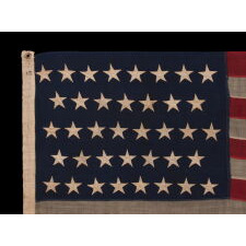 38 STAR ANTIQUE AMERICAN FLAG WITH BEAUTIFULLY HAND-SEWN STARS AND IN A SMALL AND VERY DESIRABLE SCALE AMONG ITS COUNTERPARTS OF THE 19TH CENTURY; REFLECTS THE PERIOD WHEN COLORADO WAS THE MOST RECENT STATE TO JOIN THE UNION, 1876-1889