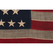 38 STAR ANTIQUE AMERICAN FLAG WITH BEAUTIFULLY HAND-SEWN STARS AND IN A SMALL AND VERY DESIRABLE SCALE AMONG ITS COUNTERPARTS OF THE 19TH CENTURY; REFLECTS THE PERIOD WHEN COLORADO WAS THE MOST RECENT STATE TO JOIN THE UNION, 1876-1889